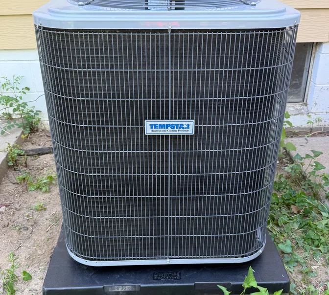 Front view of a newly installed Tempstar air conditioner by BreezeTech Heating and Cooling