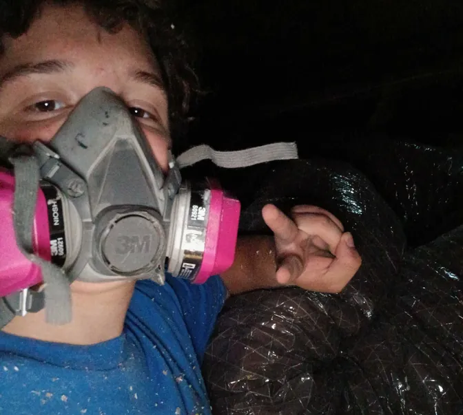 BreezeTech Heating and Cooling technician wearing a respirator while replacing ductwork