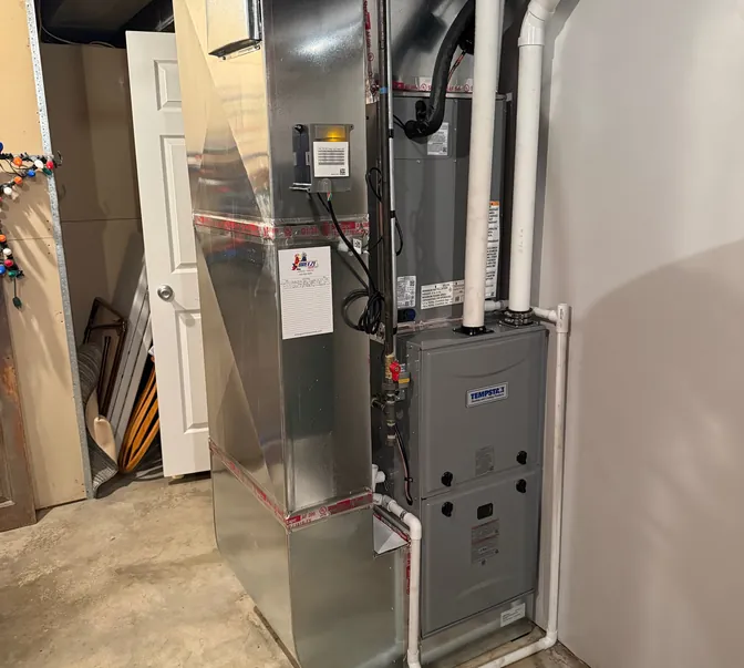 New high-efficiency furnace and coil installed in a basement by BreezeTech Heating and Cooling