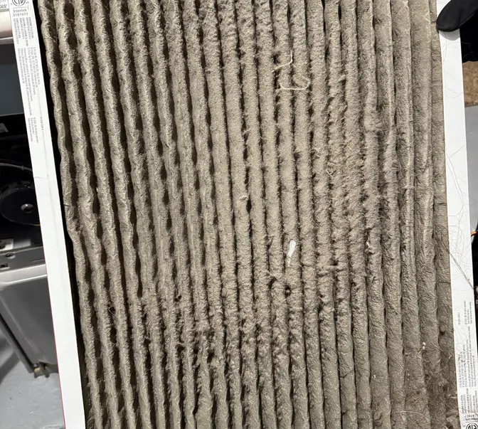 Dirty clogged furnace air filter replaced by BreezeTech Heating and Cooling