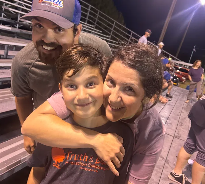 BreezeTech Heating and Cooling family sharing a hug at a hometown ballgame, homegrown values