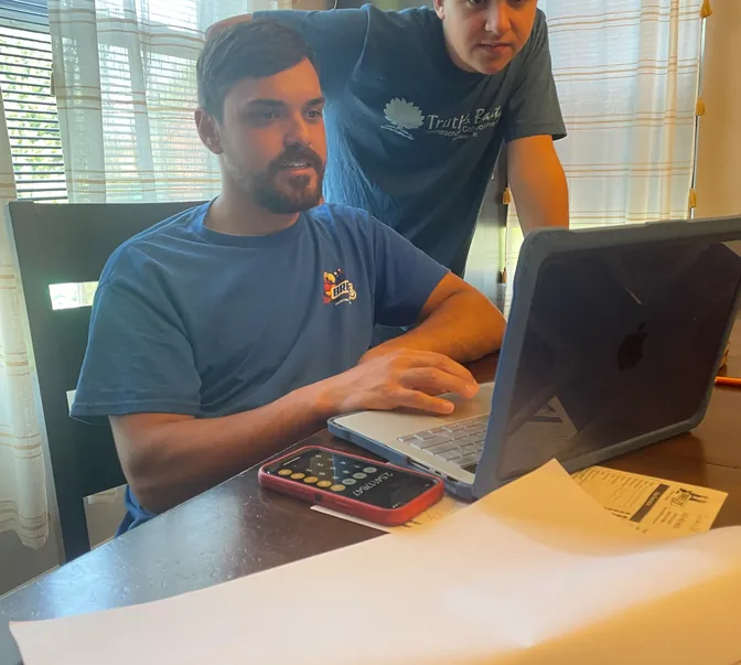 BreezeTech Heating and Cooling team members planning at the office