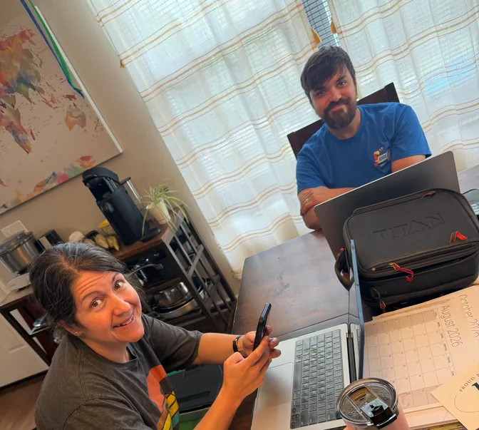 The BreezeTech Heating and Cooling husband-and-wife team working at the office table