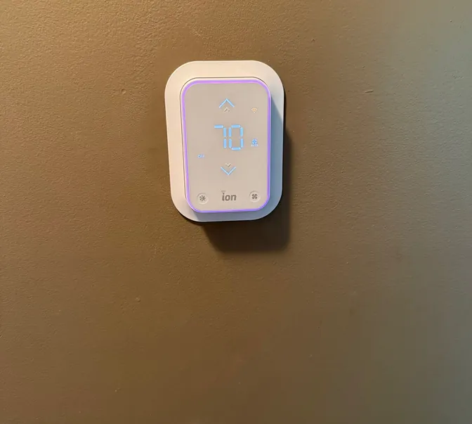 Smart thermostat installed on a wall by BreezeTech Heating and Cooling