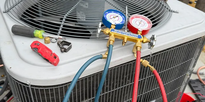 Manifold gauges and tools on a new condenser during a BreezeTech Heating and Cooling install