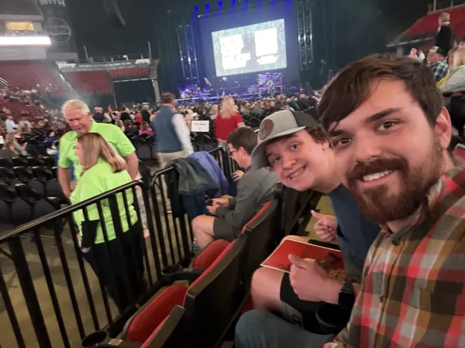 Silas and Micah smiling in their seats at the MercyMe concert in Omaha