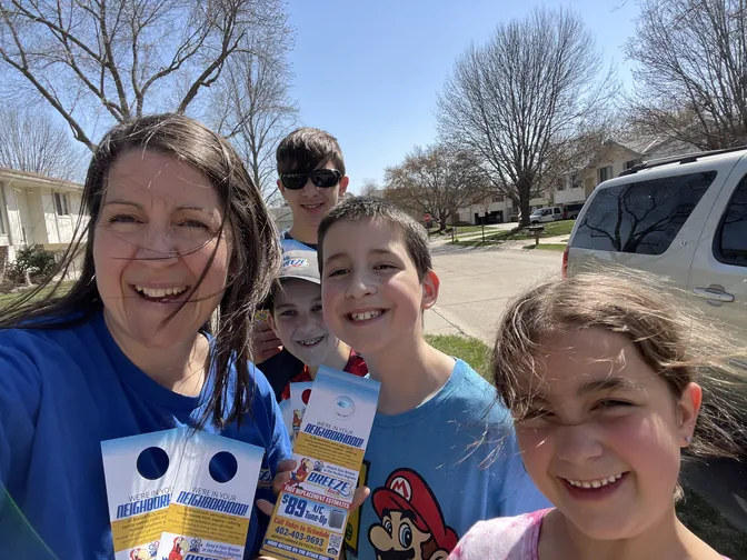 A smiling BreezeTech family selfie on a sunny day in Papillion