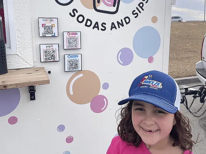 A young BreezeTech fan in a BreezeTech cap at Gracie’s Soda & Sips in Bellevue