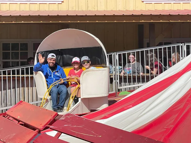 The family waving from a ride at Vala’s Pumpkin Patch