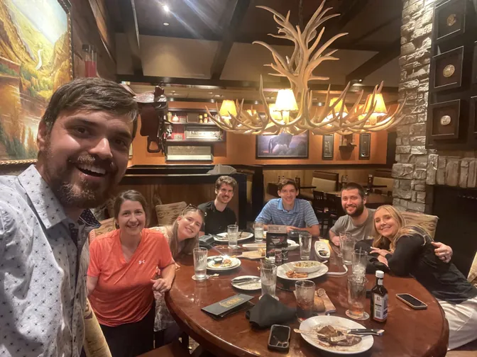 The BreezeTech team around a dinner table at LongHorn Steakhouse