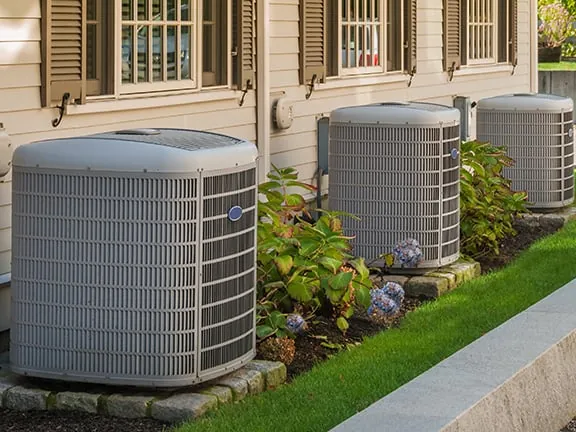 Air conditioner condensers beside a home