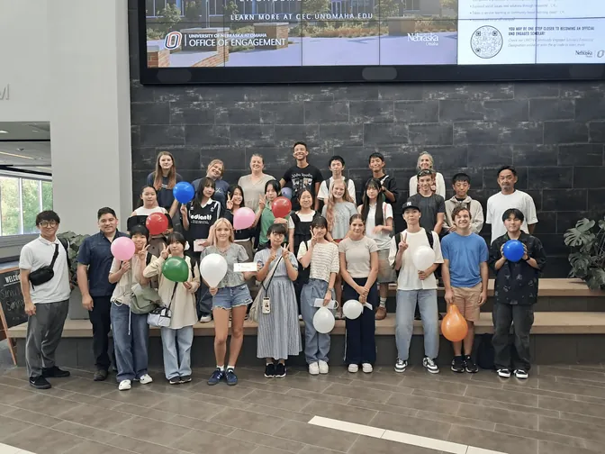 Japanese exchange students and volunteers with balloons at UNO