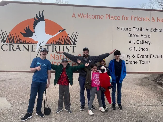 The family at the Crane Trust Nature & Visitor Center sign