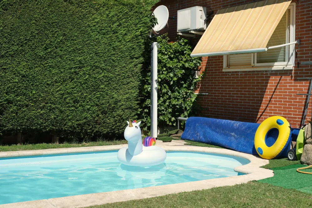 Empty swimming pool. Big inflatable unicorn floating inside pool.